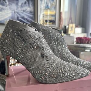Silver Stiletto Heeled Boots with Intricate Cutout Design